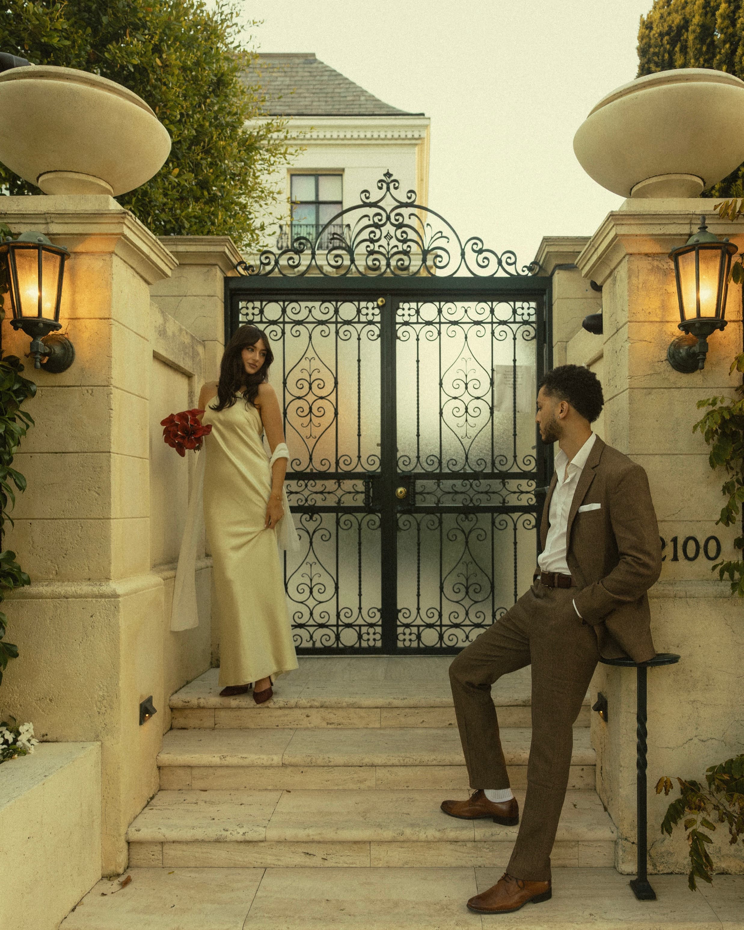 Berkeley and Robin at a wrought-iron gate outside a San Francisco home