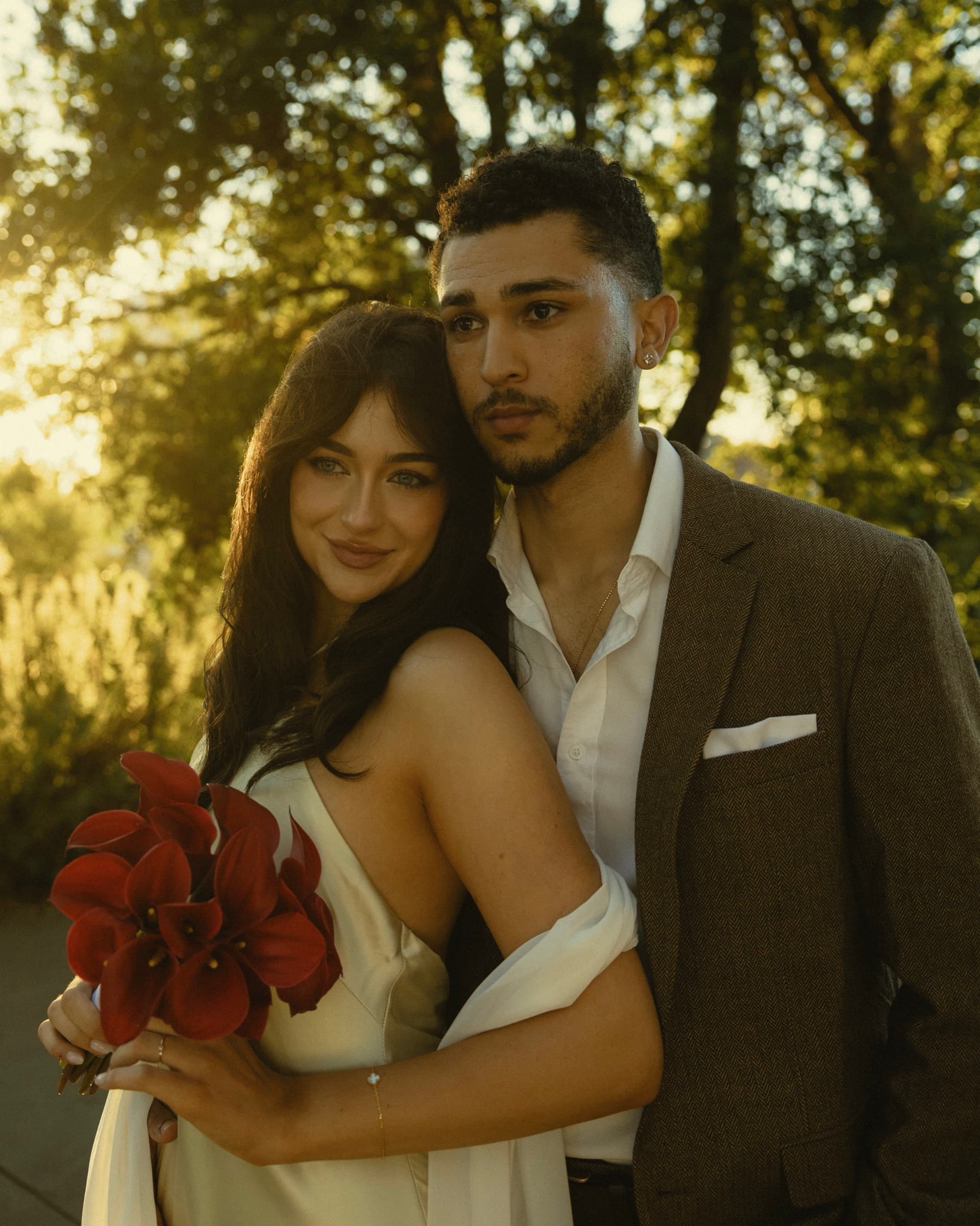 Portrait of Berkeley and Robin together, holding a deep red bouquet